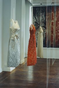 Three dresses hung in a line.