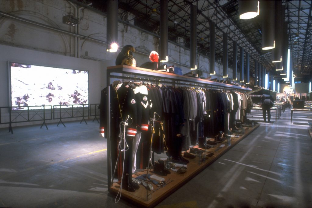 Exhibition display of a row of uniforms and masculine garments