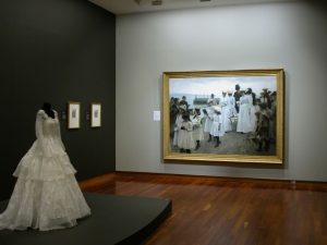 18th century gown on display in front of a painting