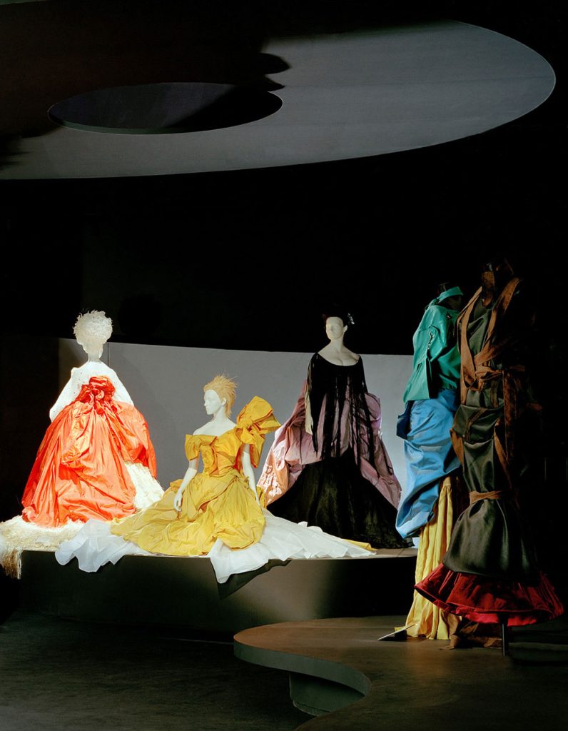 Exhibition display of mannequins in day-glo coloured 17th Century period style costume