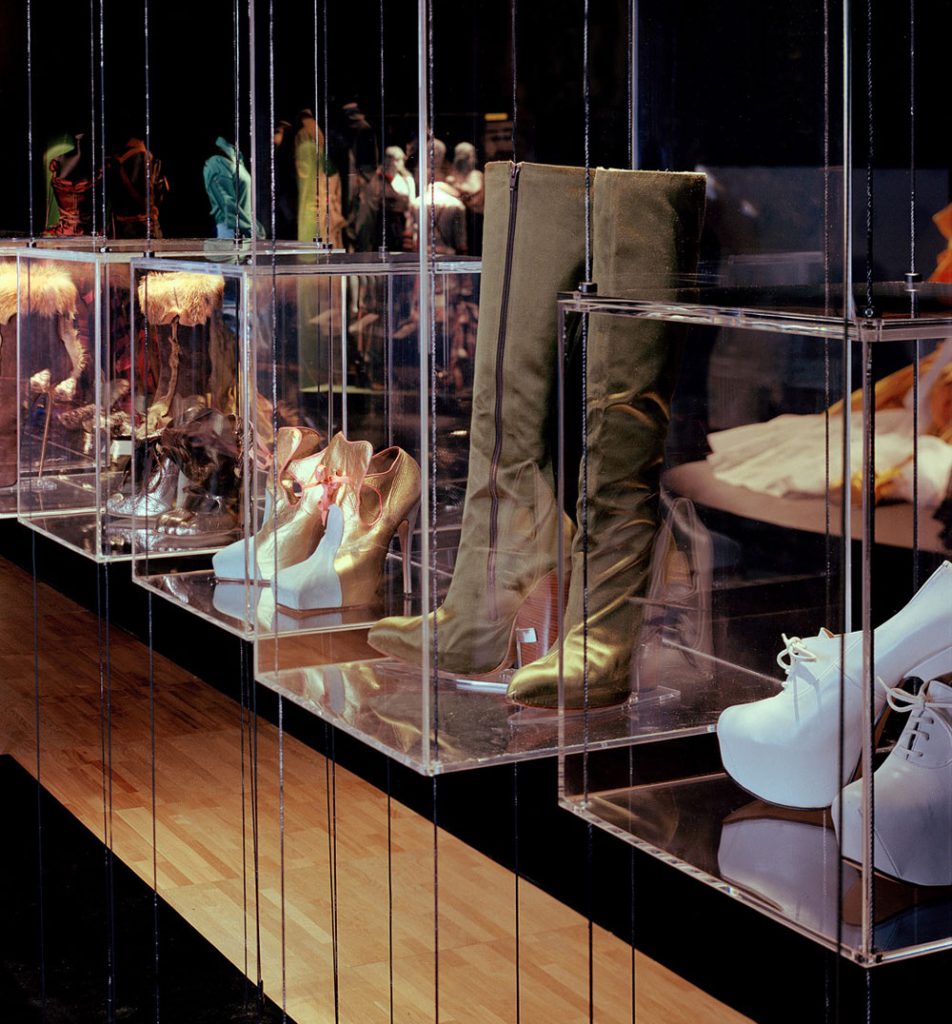 Exhibition installation shot of various kinds of footwear on plinths