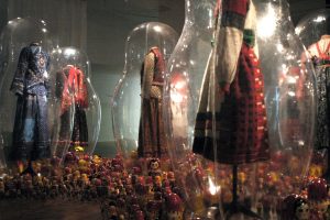 Exhibition display of dressed mannequins in transparent cases