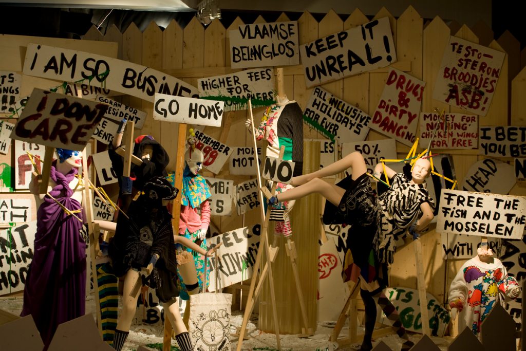 Exhibition display of dress with protest signs