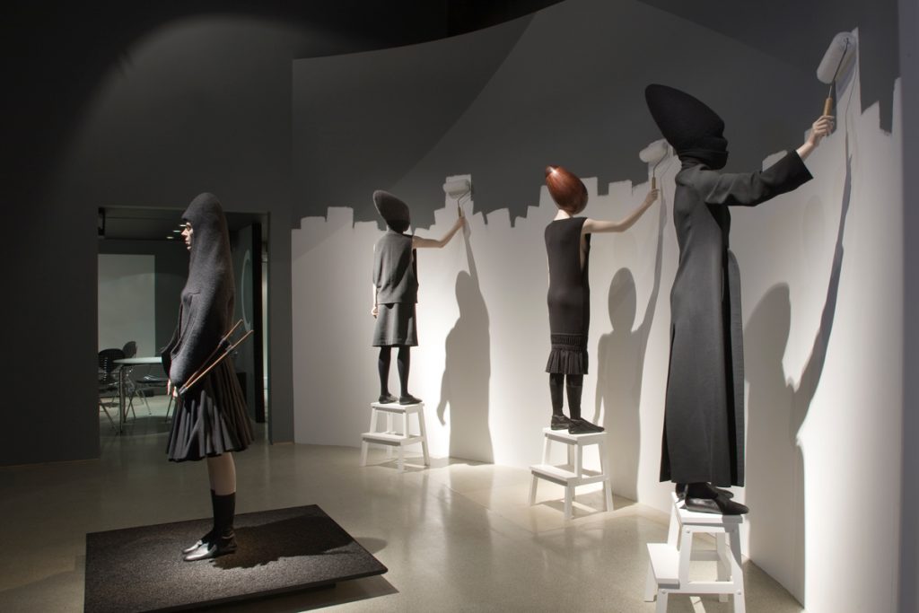 Exhibition display of four dressed mannequins