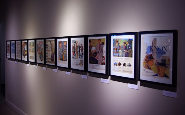 Exhibition with framed images on the wall.