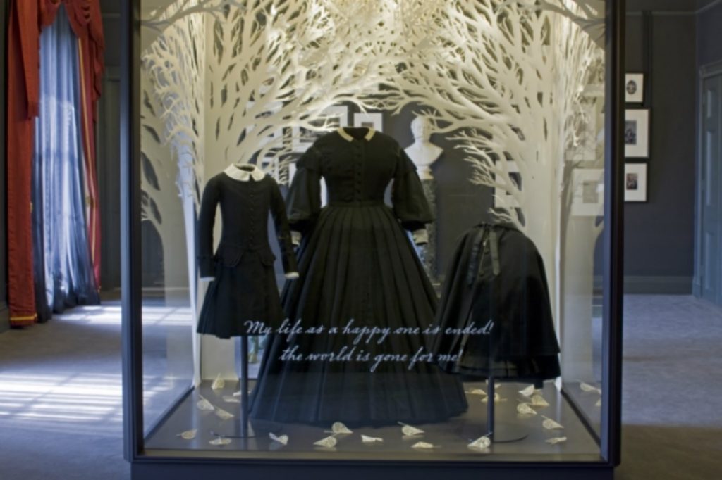 Exhibition display of dressed mannequins wearing Queen Victoria's mourning gown