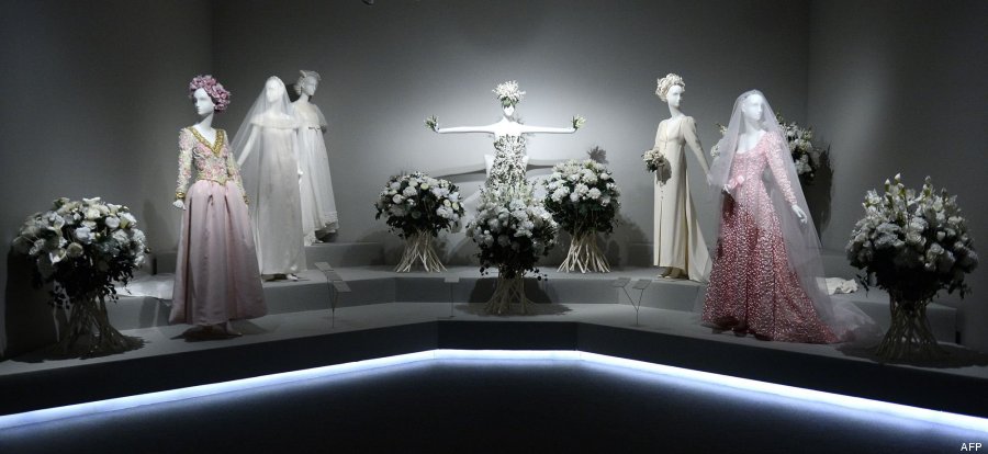 Exhibition display of dressed mannequins in bridal style veils and ghostly light