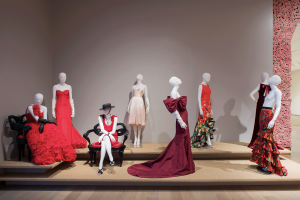 Exhibition display with eight mannequins display Oscar de la Renta garments.