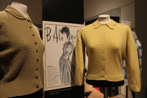 Exhibition display of mannequins dressed in mustard coloured jumpers