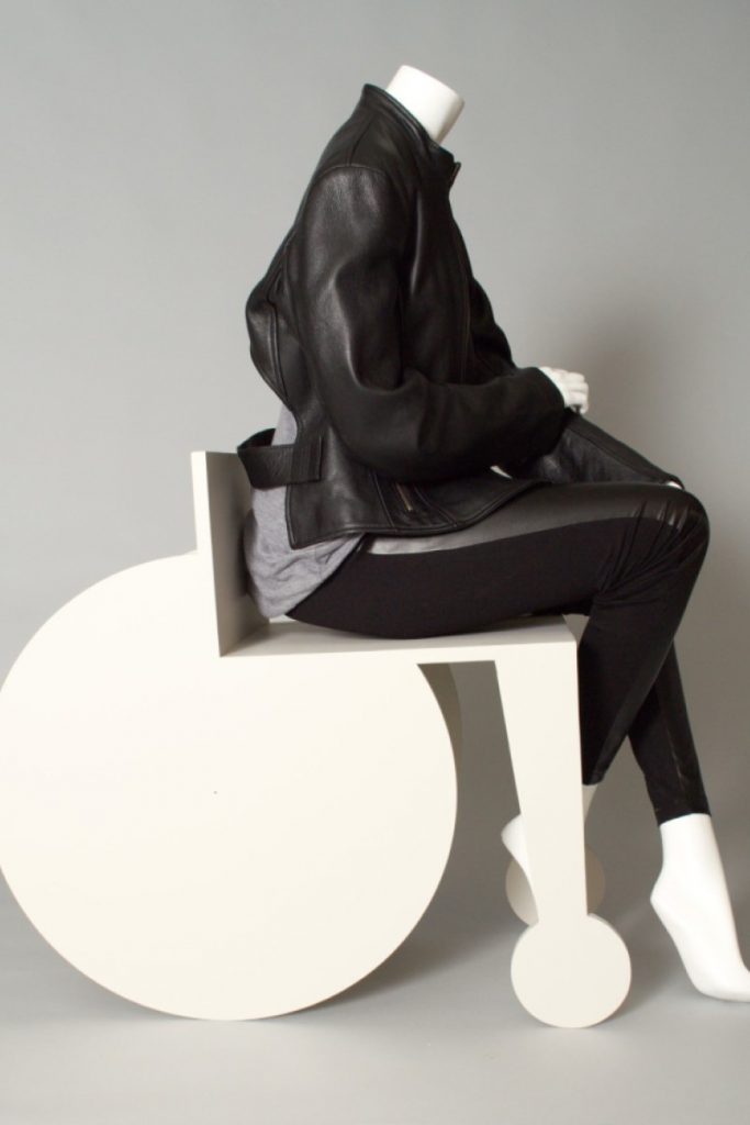 Exhibition display of mannequin in white stylised wheelchair