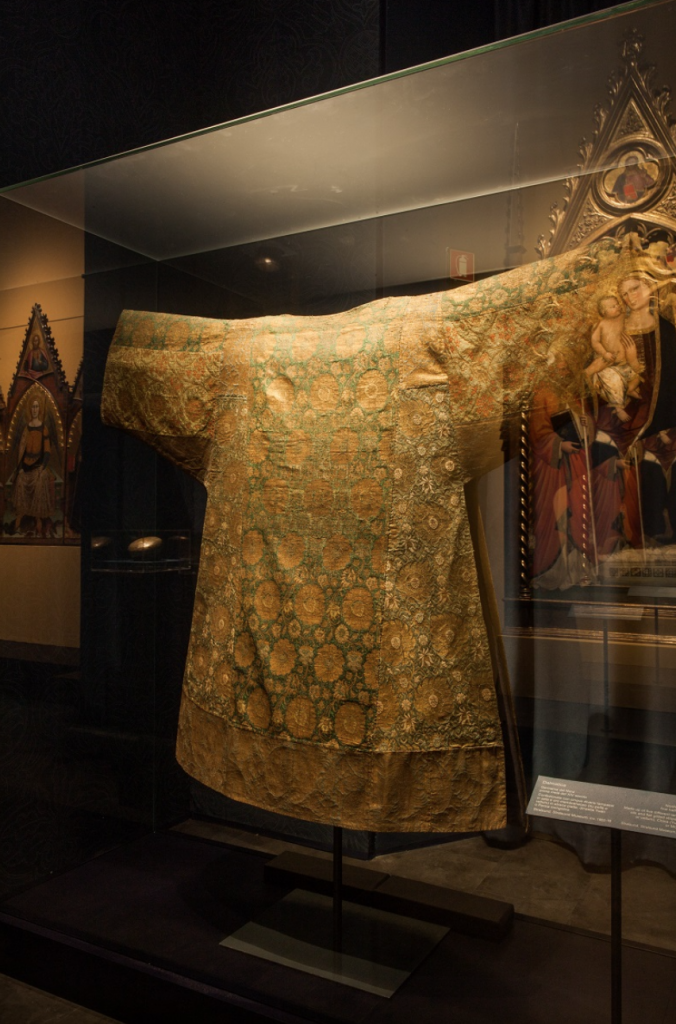 Exhibition display of gold coloured garment