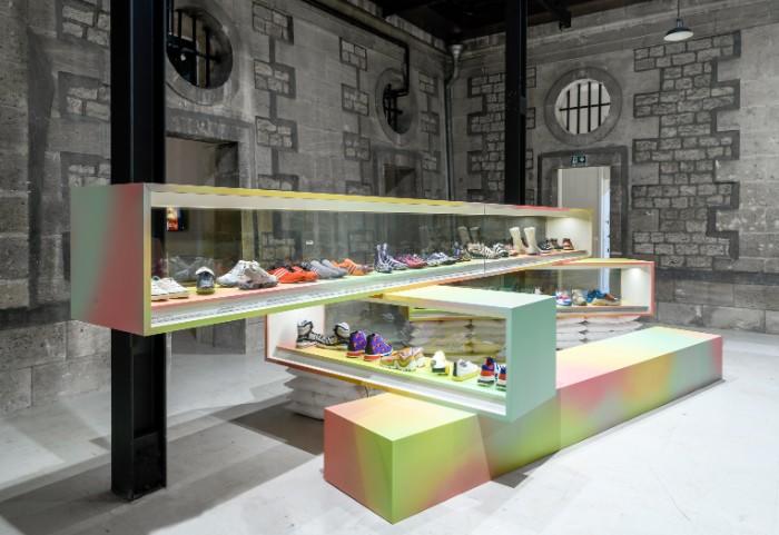 Exhibition display of trainers on colourful plinths