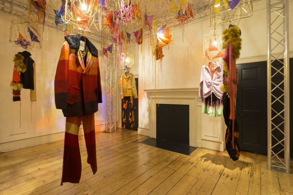 Exhibition display of garments suspended in the air