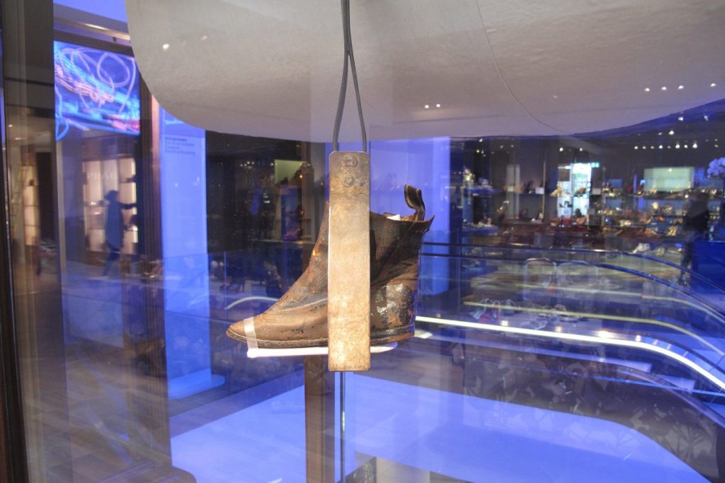 Exhibition display with ankle boot