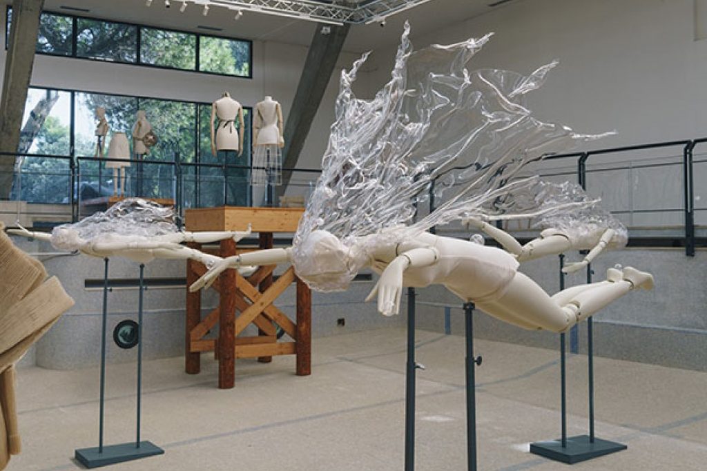 Exhibition display of diving mannequins with splash material surround