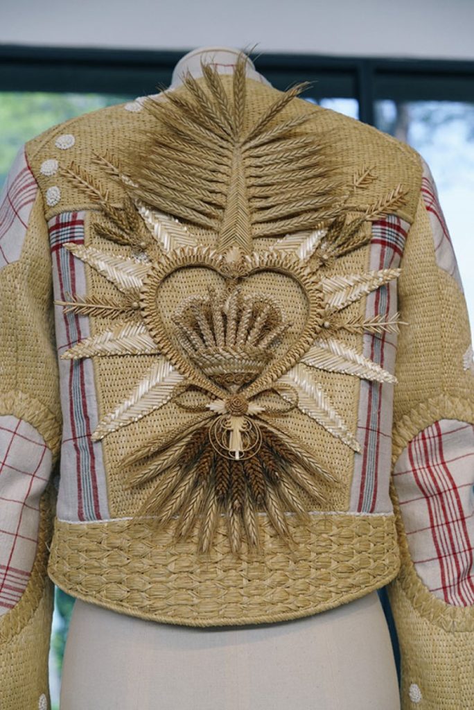 Exhibition display of back of jacket with golden corn motif