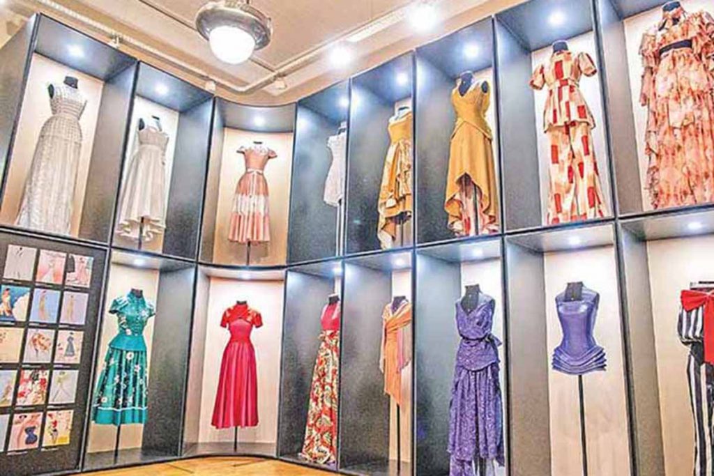 Exhibition display of dressed mannequins on alcoves at floor and ceiling height