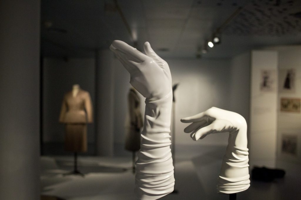 Exhibition display of long white gloves on manequin hands