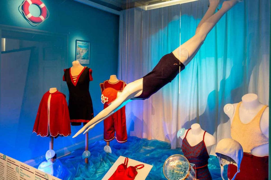 Exhibition display of dressed mannequins in swim wear
