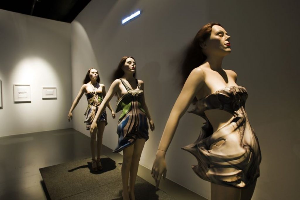 Exhibition display of dressed mannequins with the appearance of facing into a wind