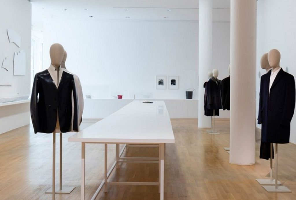 Exhibition display of dressed mannequins and trestle table