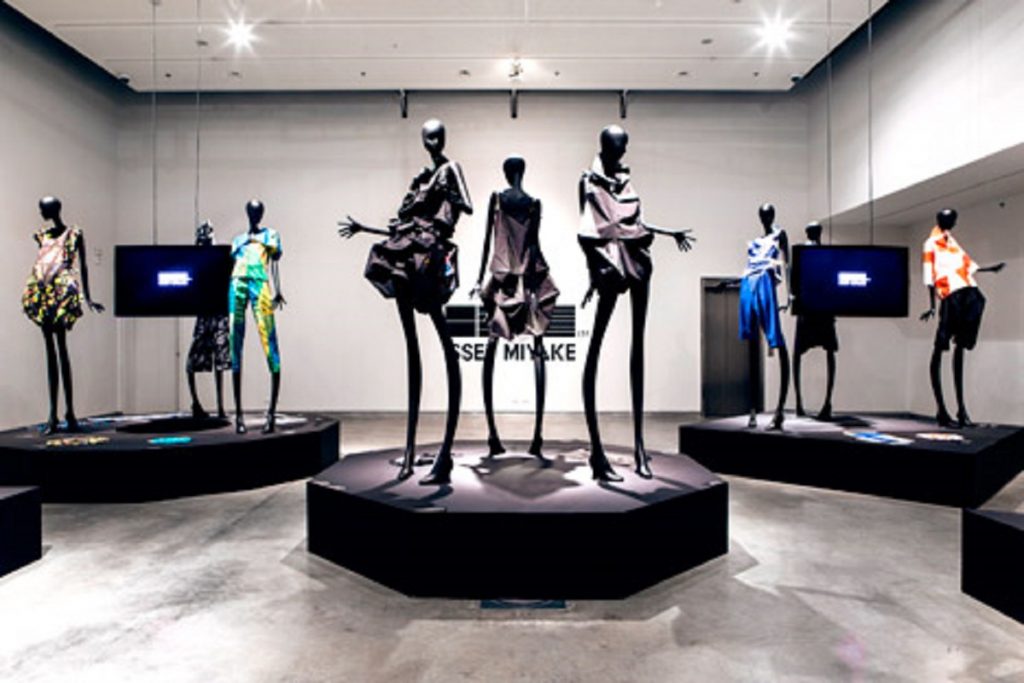 Exhibition display of elongated dressed mannequins