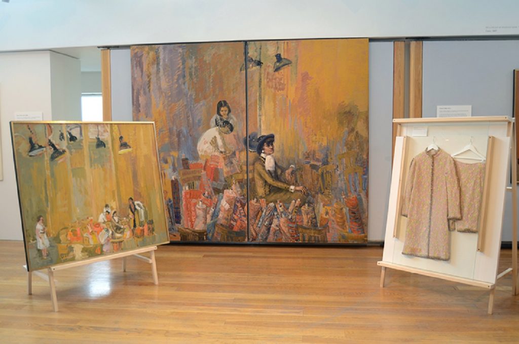 Exhibition display of paintings and clothing