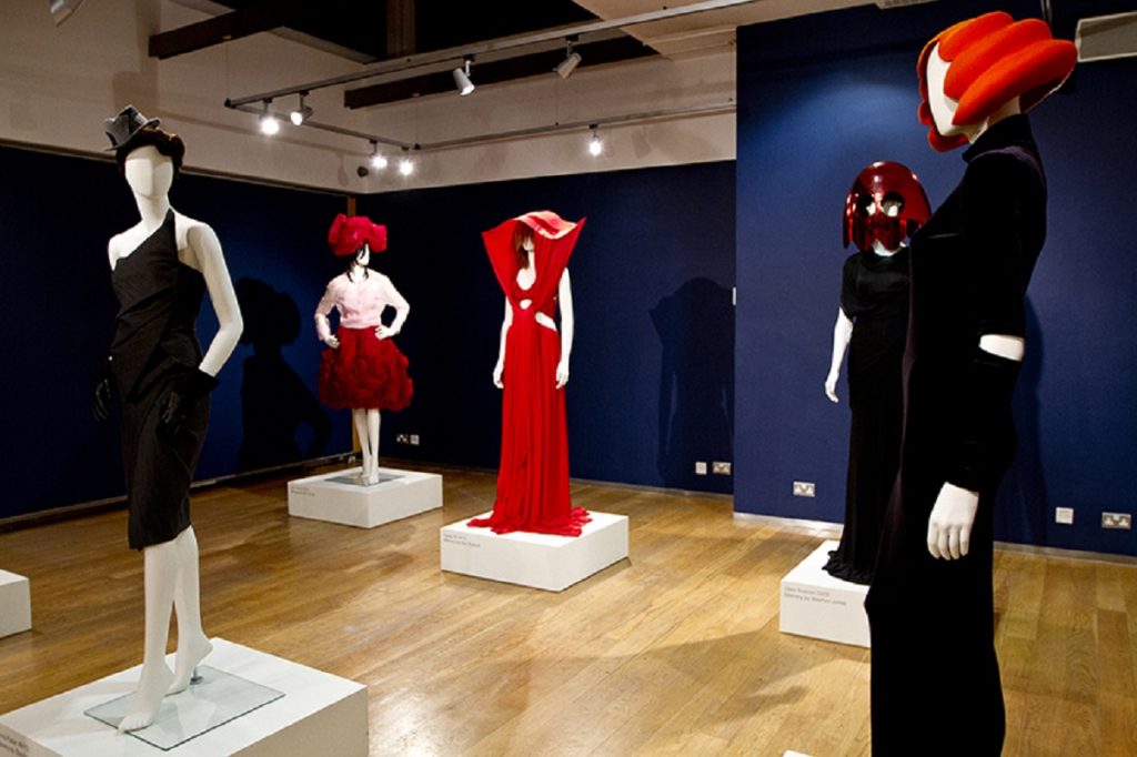 Exhibition display of dressed mannequins with headwear