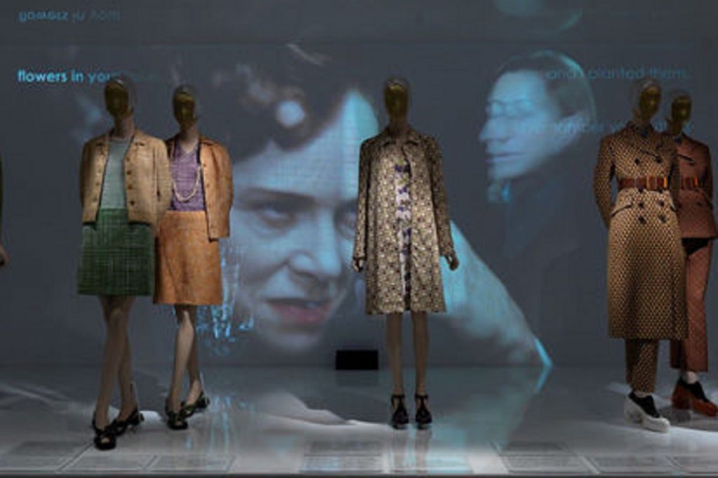 Exhibition display of dressed mannequins and projected imagery
