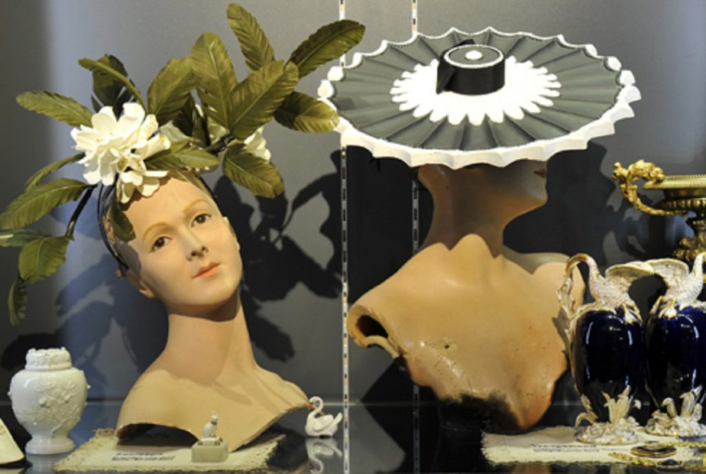 Exhibition display of mannequins with headpieces