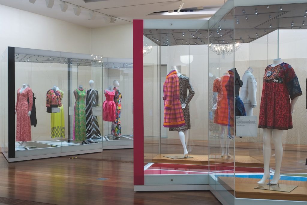 Exhibition display of dress in glass vitrines