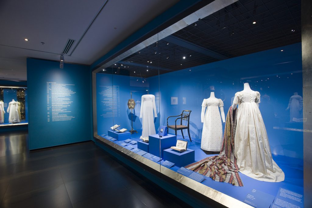 Exhibition display of dress within built in glass vitrine