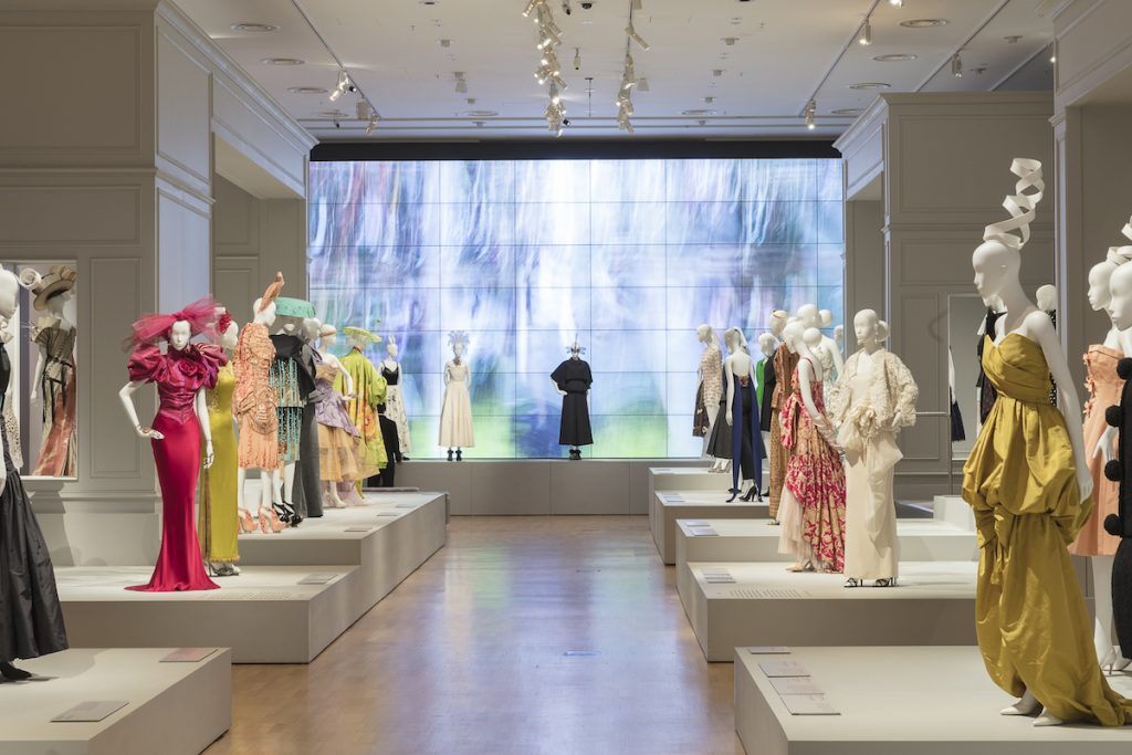 Room view of exhibition display of dress on open display plinths