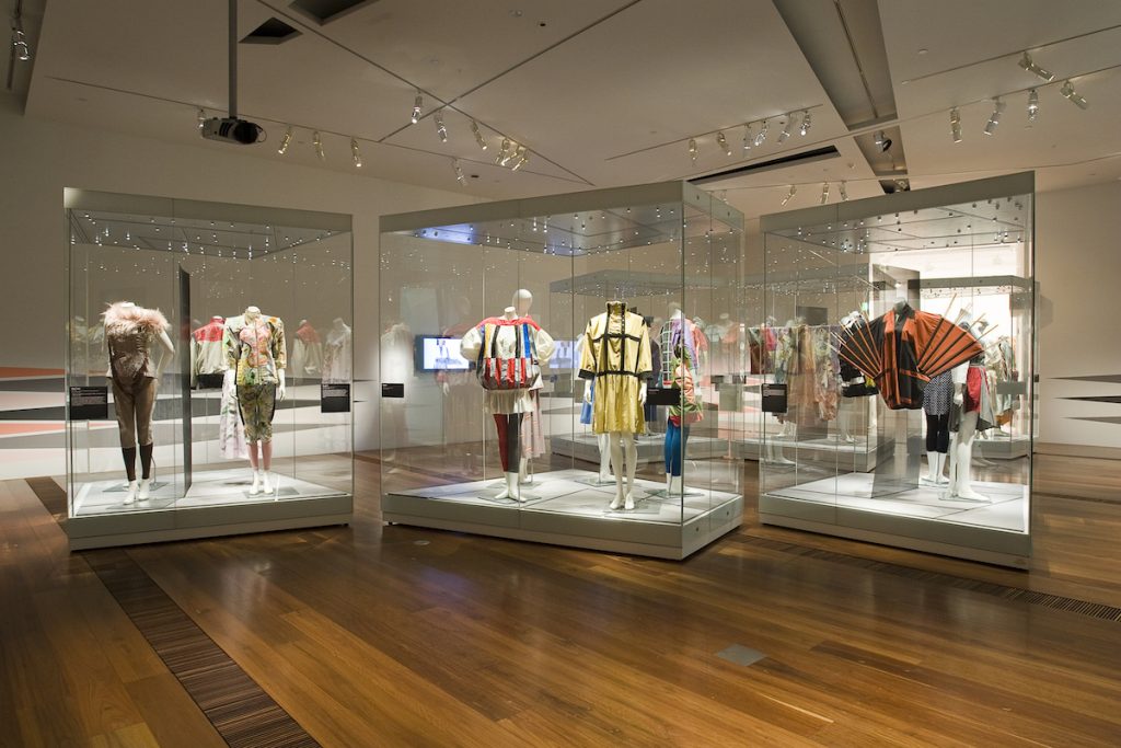 Exhibition display of dress in glass vitrines