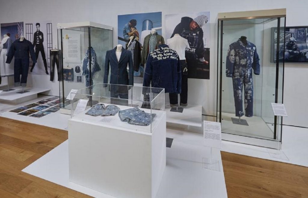 Exhibition display of dressed mannequins in denim outfits