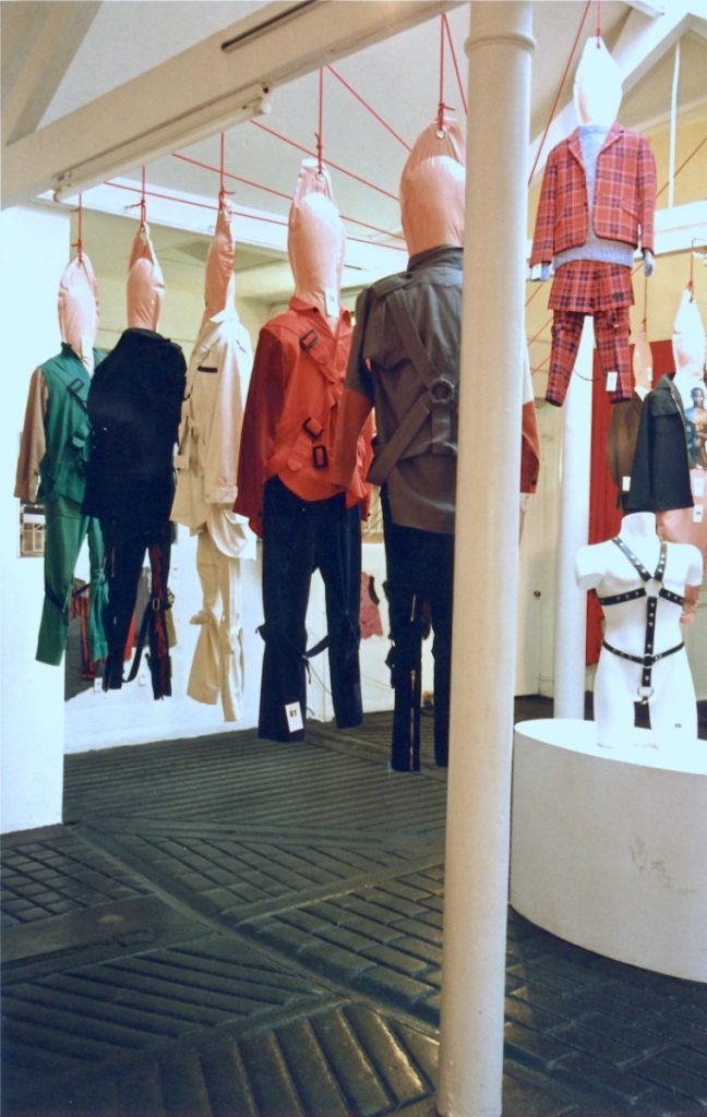 Exhibition display of dressed mannequins suspended