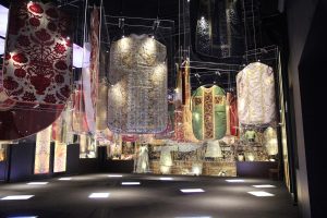 Exhibition display of tunics suspended
