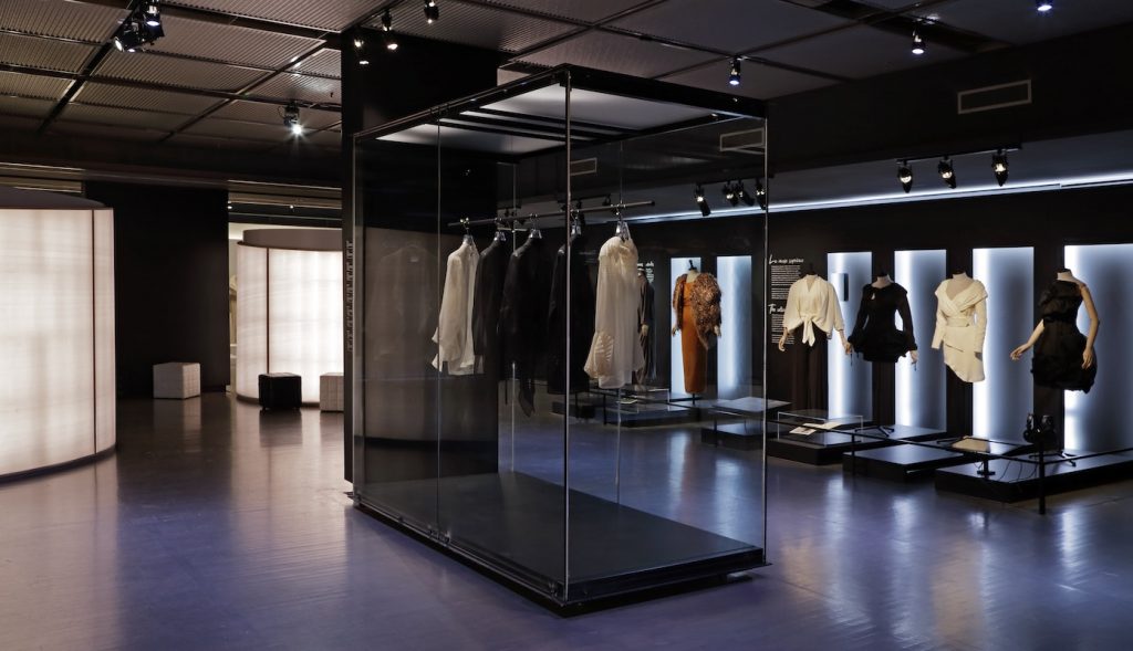 Exhibition display of dress in glass vitrine