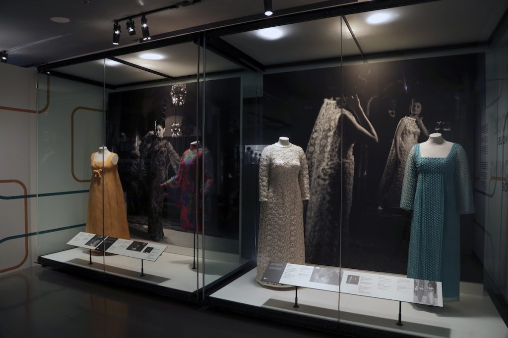 Exhibition display of dress in glass vitrine