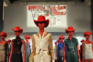 Exhibition display of red mannequins in red hats