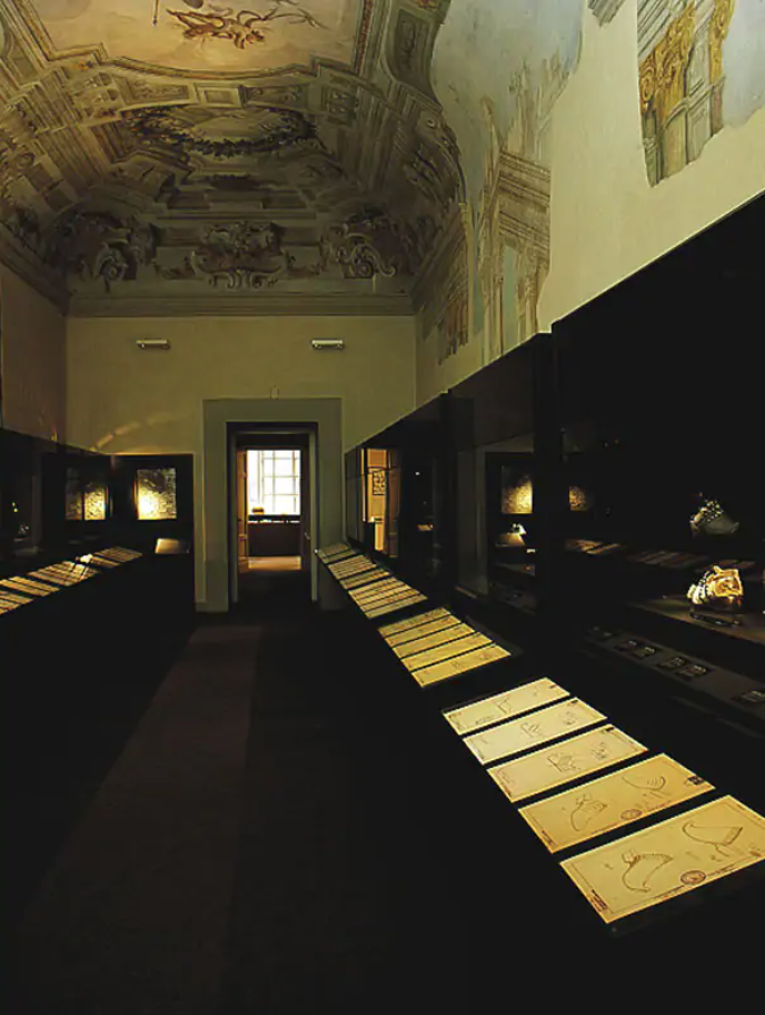 Exhibition display of documents in a cabinet situated in a long room