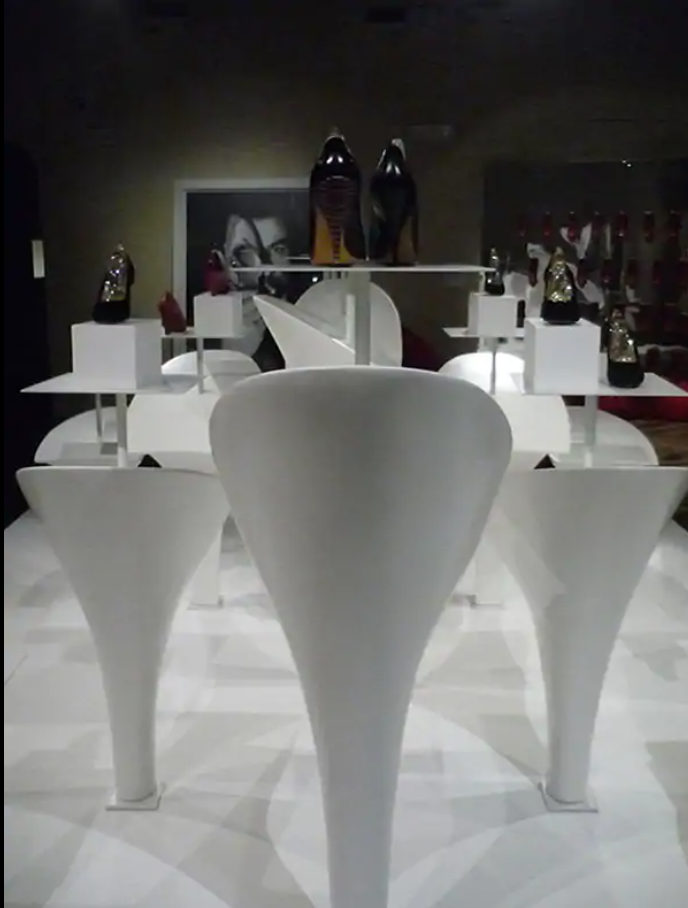 Exhibition display of white cone shapes plinths