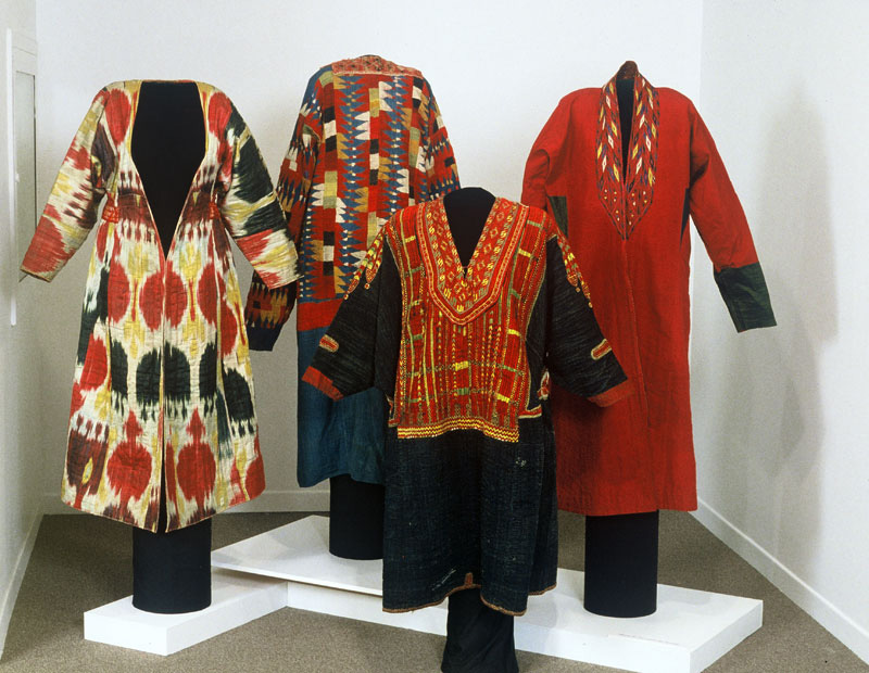 Exhibition with mannequins on a plinth displaying garments from Afghanistan.