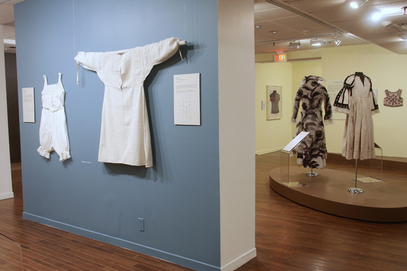 display of exhibition mannequins and garments on the wall