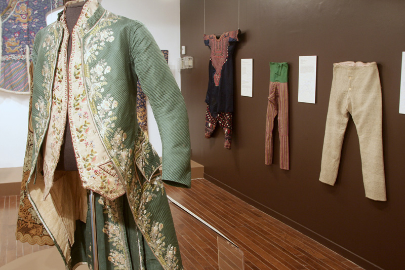display of exhibition mannequins and garments on the wall