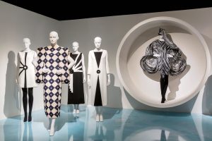 Exhibition with mannequins displaying Pierre Cardin garments.