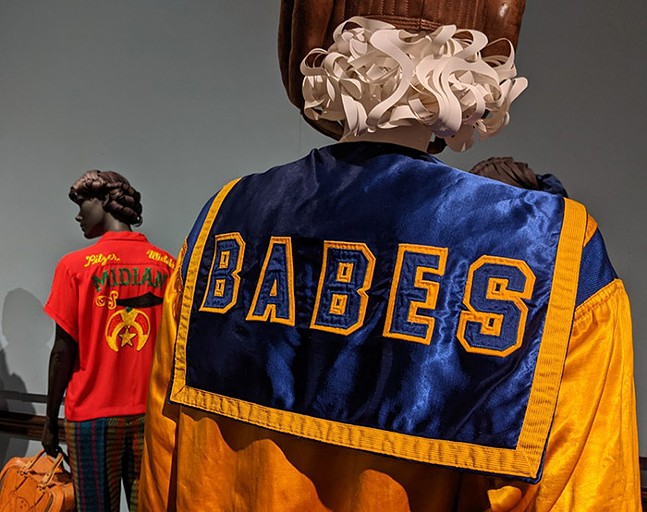 Exhibition with mannequin displaying women's boxing jacket.