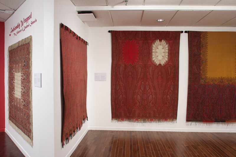 Exhibition with white walls with textiles hangings,