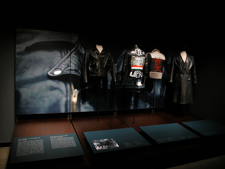 exhibition display of mannequins dressed in leather menswear
