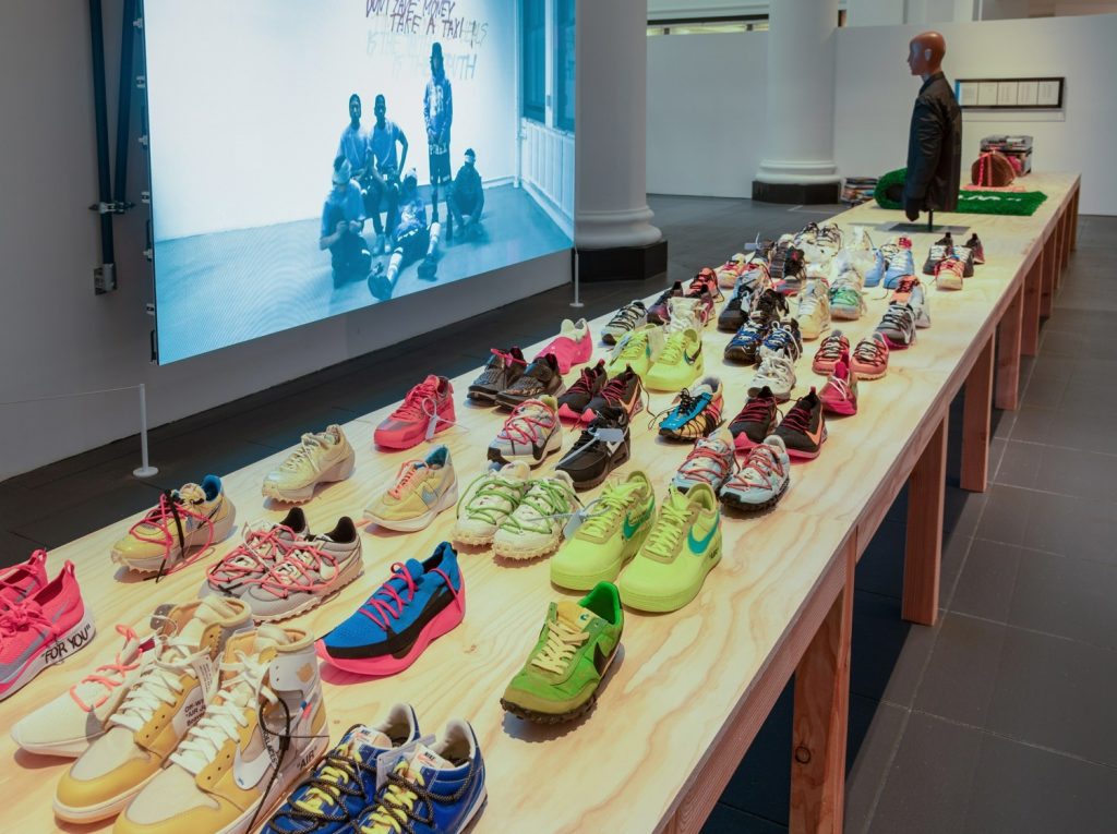 exhibition display of shoes on a long display table